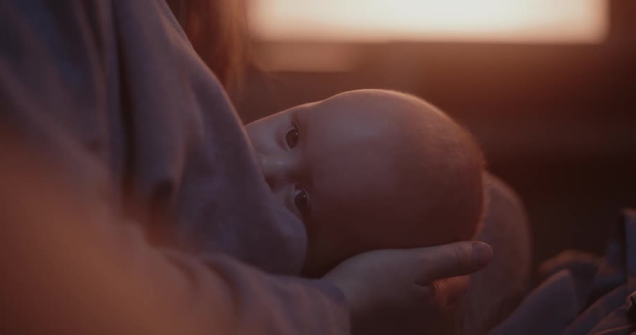 A mother is holding her baby