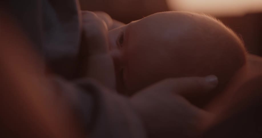 Mother breastfeeds newborn baby