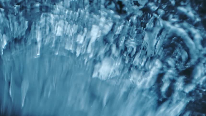 An extreme close up of water moving around and rippling on the surface