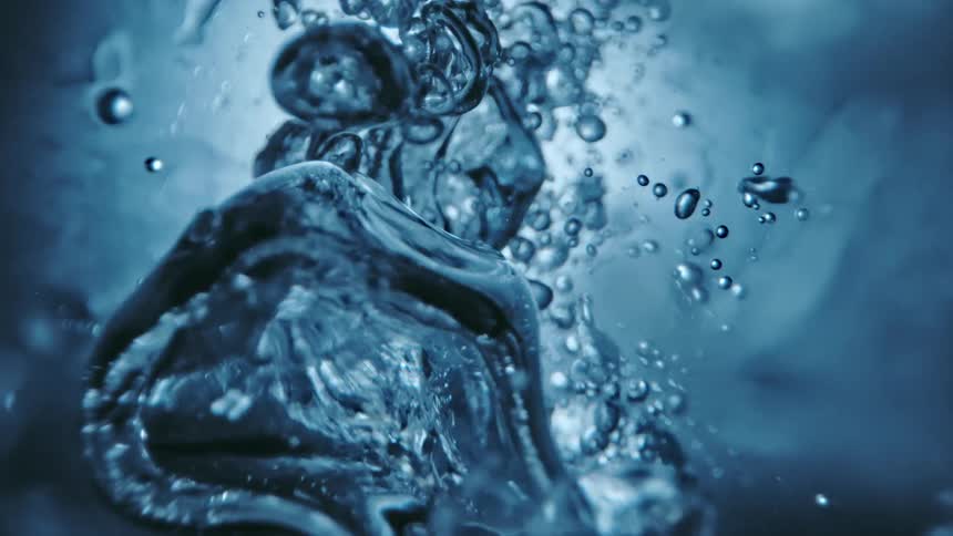 Top down close up of clear water rippling and splashing towards the camera