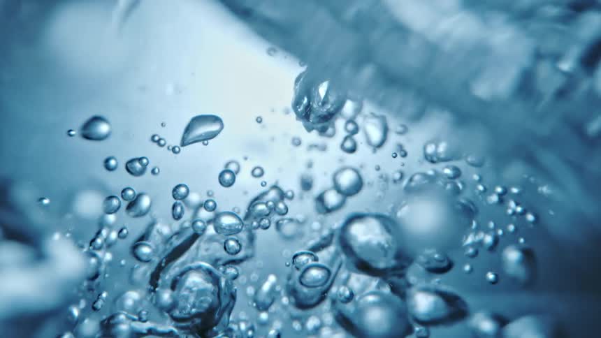 Underwater footage of agitated air bubbles moving around in clear water