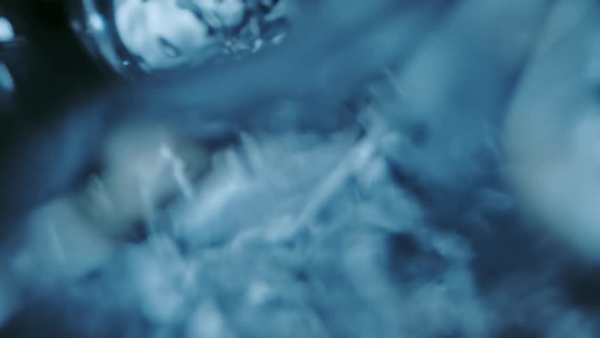 A close up of water droplets under water moving around
