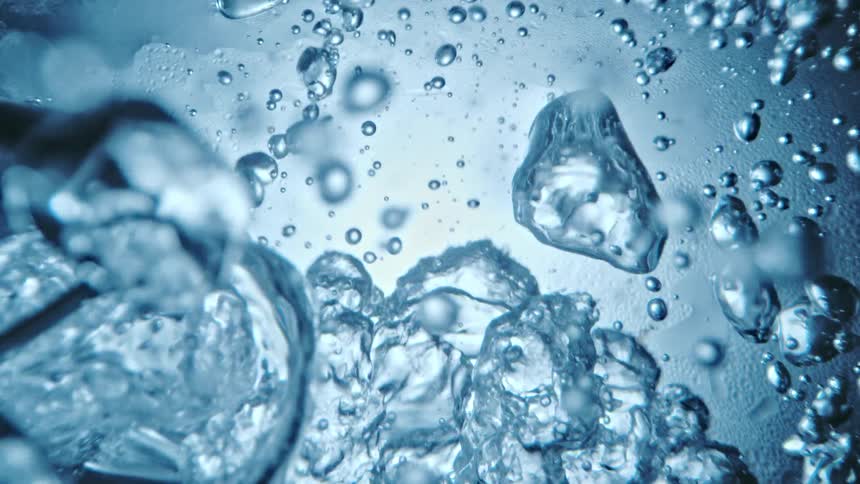 Water moves and ripples as air bubbles float and rise to the surface