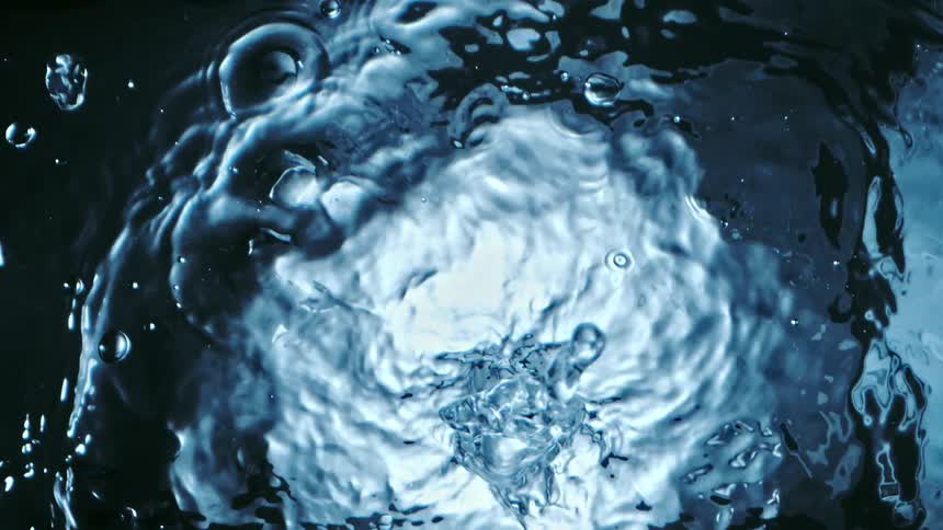 Top down close up of clear water rippling and splashing towards the camera