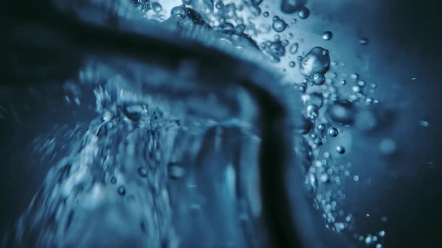 Underwater footage of agitated air bubbles moving around in clear water