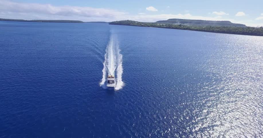 A boat is moving fast in the blue water