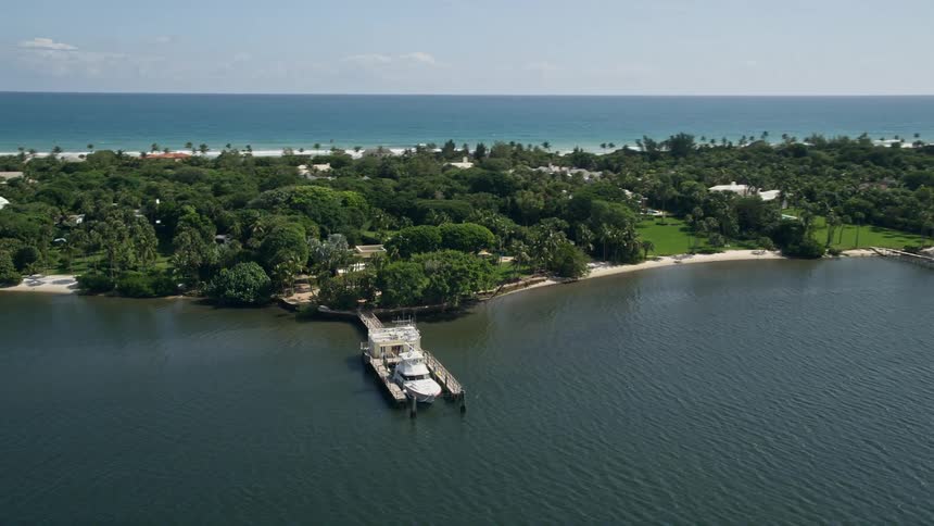 Aerial footage of a fishing boat docked on the Indian River by Hobe Sound Florida on a sunny day