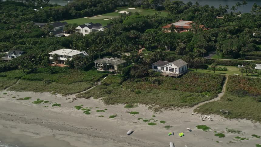 Aerial footage of beachfront homes in Hobe Sound Florida showcasing the picturesque seaside neighborhood in the sunshine state