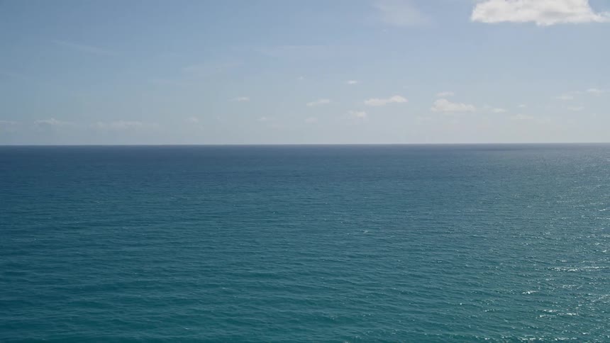 An aerial view of calm blue waters in the Atlantic Ocean off the coast of Florida on a sunny day