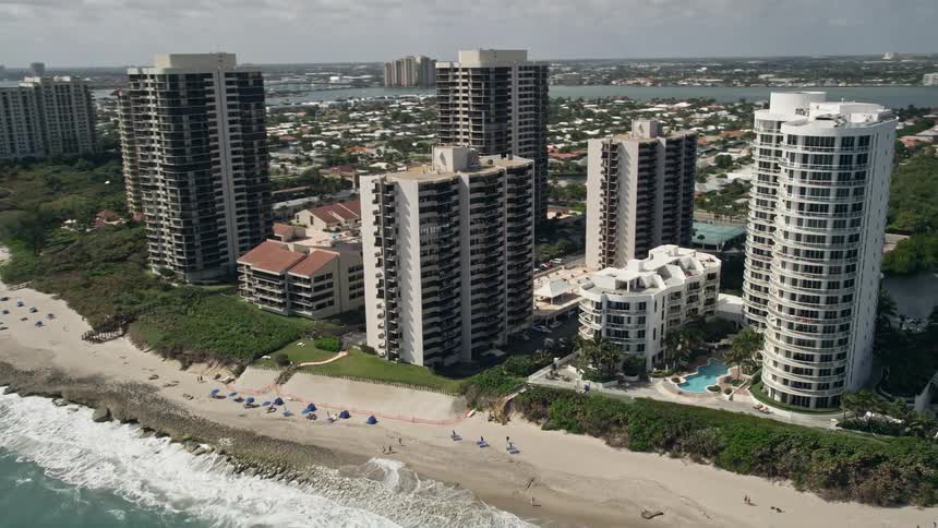 Aerial footage of the beachfront condominium complexes by the ocean in Riviera Beach Florida