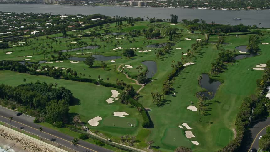 Aerial footage of a picturesque golf course by the oceanfront in Palm Beach Florida