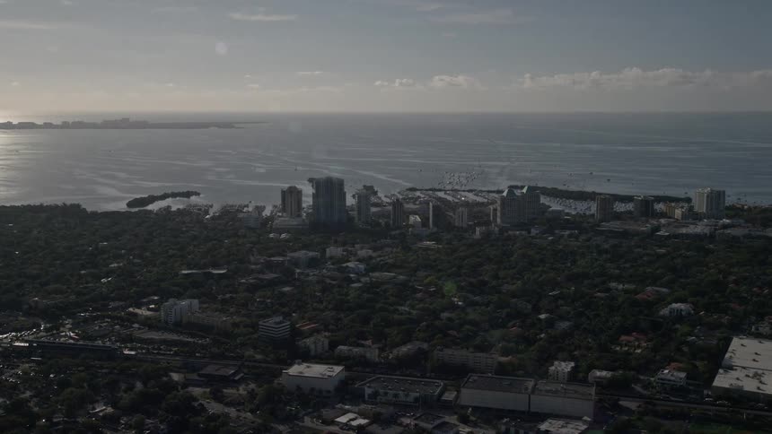 A stunning aerial view of upscale hotels and coastal apartment buildings in Coconut Grove Florida overlooking the Atlantic Ocean