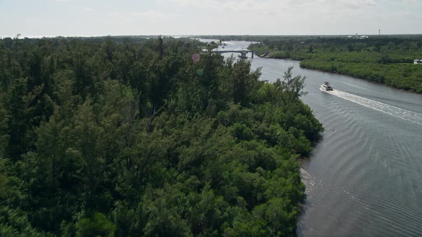 Approaching bridge over mangroves lining the Indian River near Hobe Sound Florida while flying over the water