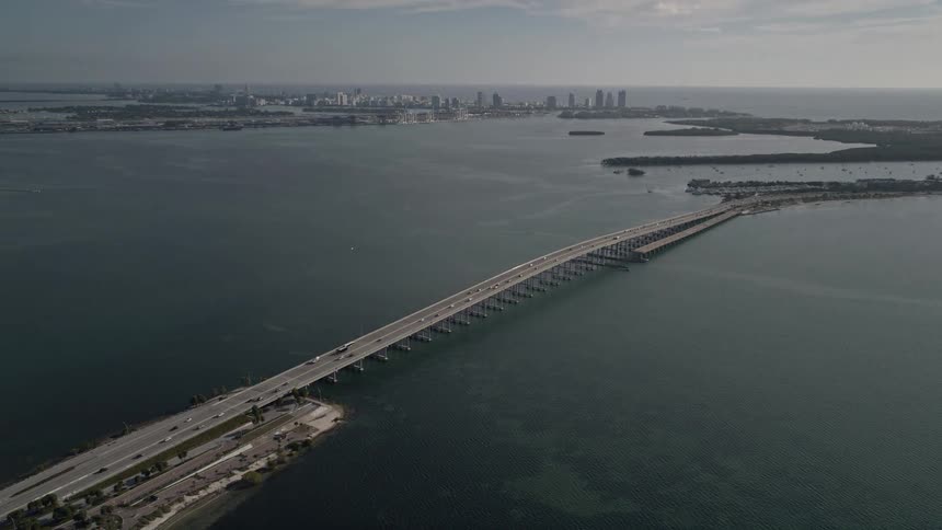Flying over the Rickenbacker Causeway on Biscayne Bay in Florida revealing a large bridge enabling transportation over a natural waterway
