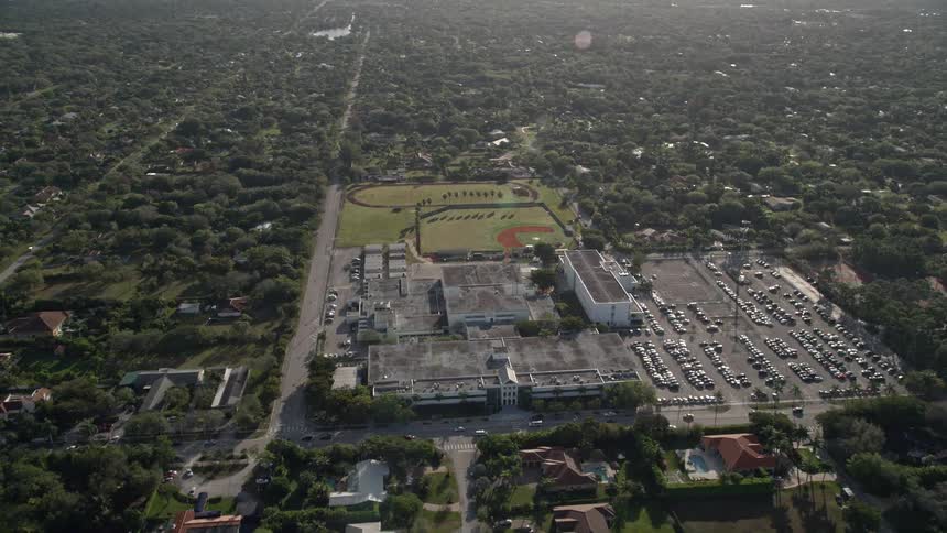 Approaching Miami Killian Senior High School a large educational facility situated in a sunlit suburban community of Kendall Florida