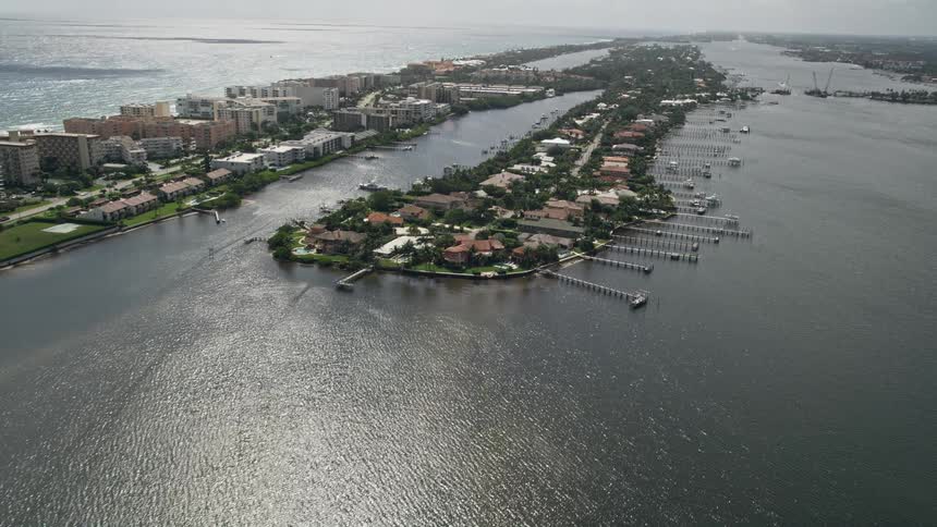 Approaching waterfront mansions on a small island in Lake Worth Palm Beach Florida