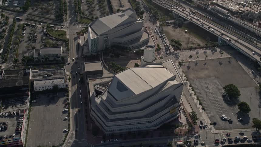 Fly over the Adrienne Arsht Center for the Performing Arts located in downtown Miami with a stunning aerial view showcasing the citys beautiful architecture and sunny weather