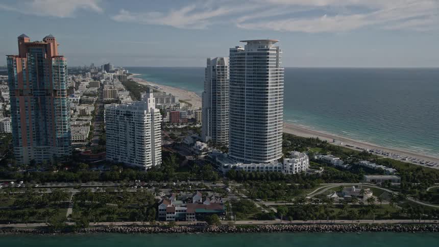 Fly above Portofino Tower and other skyscrapers near the sunny beaches of Miami Florida along the South Beach coastline in this 5K aerial video footage