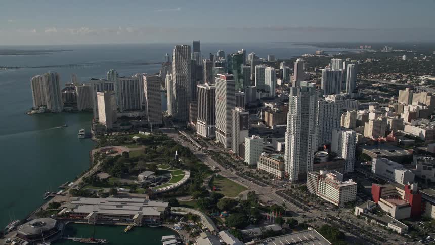 Enjoy stunning aerial views of the iconic American Airlines Arena Bayfront Park downtown Miamis sleek high-rise buildings and beautiful coastline bathed in sunshine