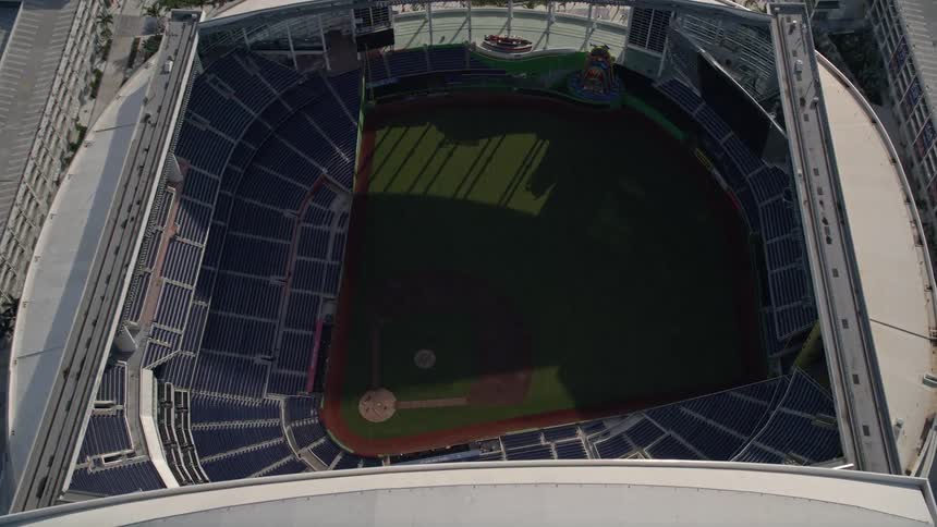Approaching Marlins Park baseball stadium from an aerial view with sunshine and clear skies in Miami Florida