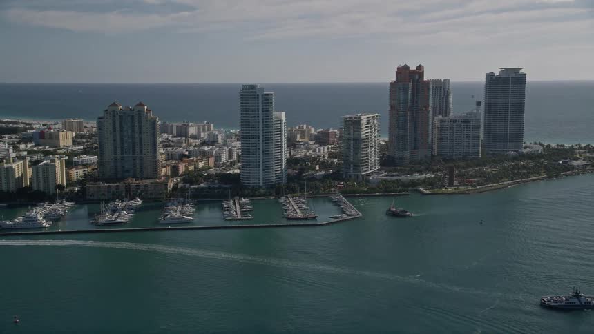 Approaching Miami Beach Marina via an aerial view showcasing the towering skyscrapers of South Beach Florida