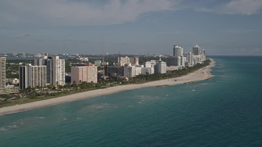 A stunning aerial view of Miami Beachs South Beach hotels and coastline on a sunny day