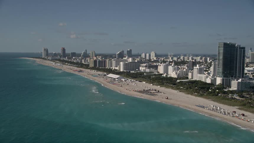 Aerial view of South Beach Miami Beach showing hotels along the coastline amidst sunshine and beachgoers