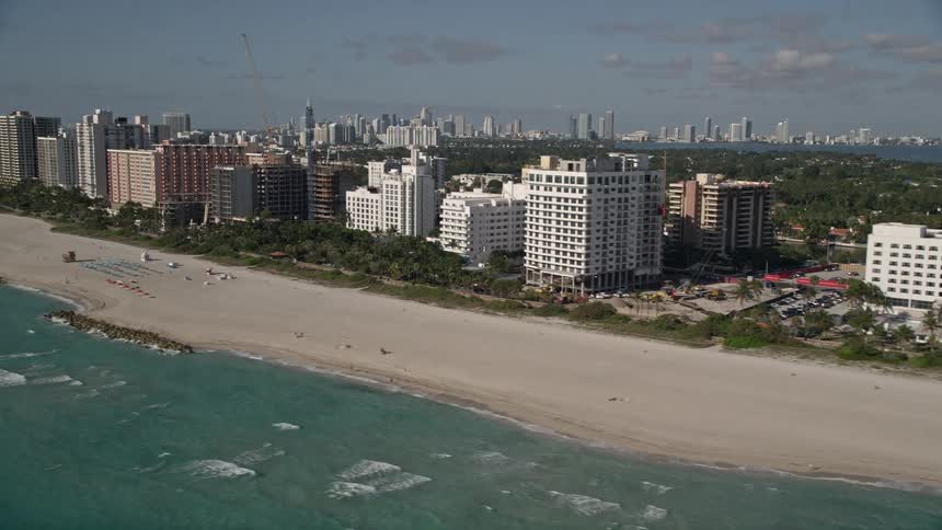 An aerial view of hotels and condo complexes on the coastline of Miami Beach Florida