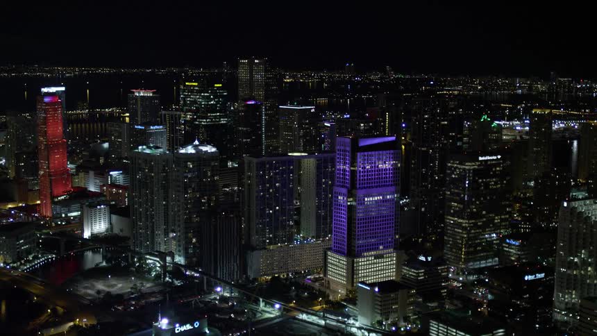 An aerial view of Brickell World Plaza at nighttime in Downtown Miami Florida with the cityscape lit up by lights