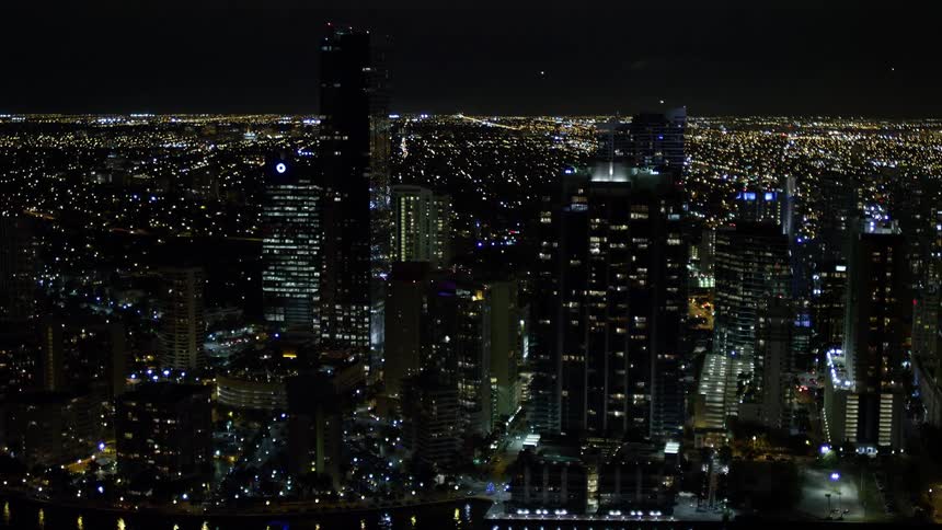 A stunning 5K aerial footage capturing the mesmerising skyline of Downtown Miamis Jade at Brickell Bay with towering buildings glimmering at night and clear scenic views of the shoreline and water