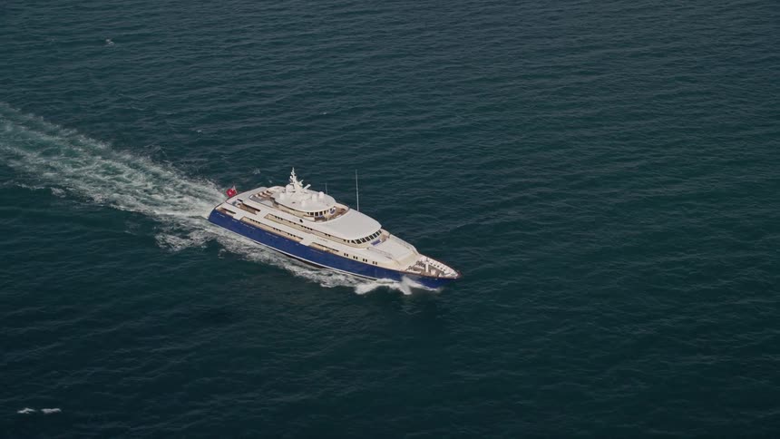 A yacht is tracked while cruising through the Atlantic Ocean in the sunny and clear weather of Miami Florida