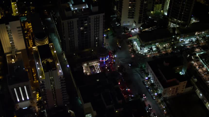 A stunning aerial view of Bancroft Hotel at night in South Beach illuminated with colorful lights