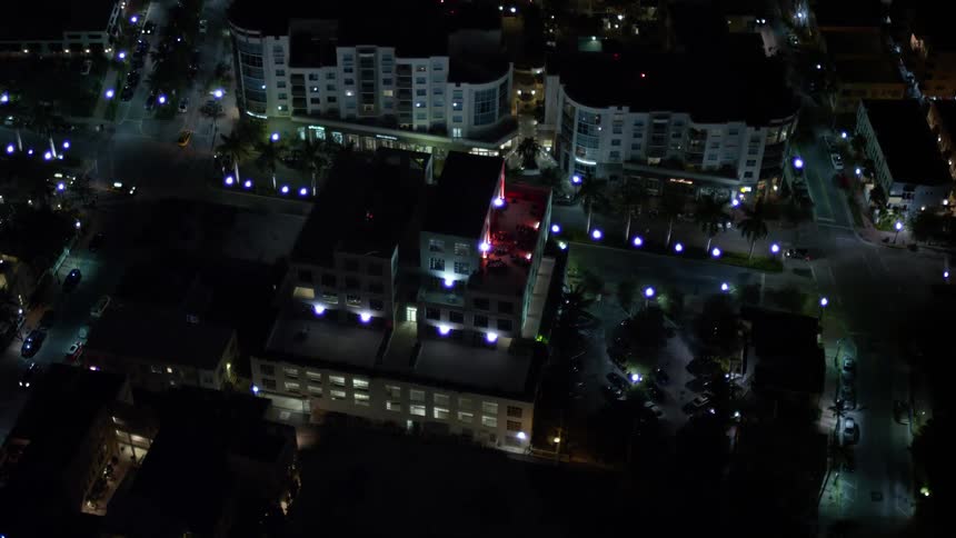 An aerial night view of the South Beach office building in Florida as seen from above while approaching the area