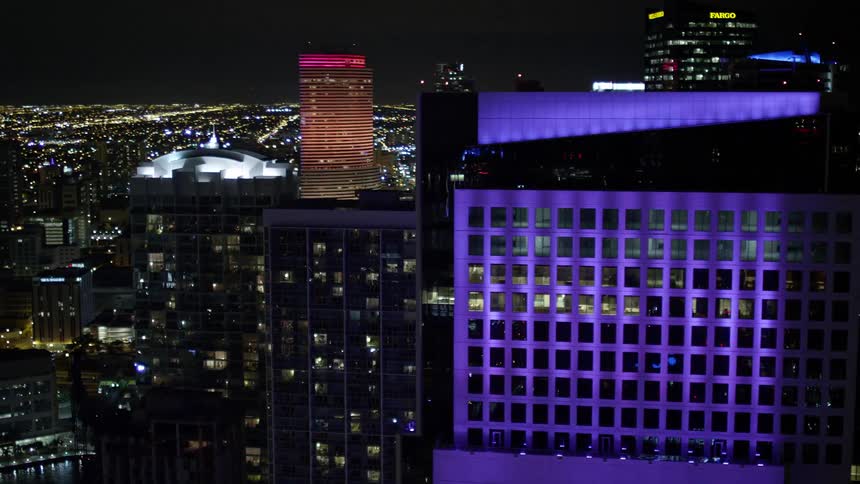Aerial view at night of the tall modern buildings at Brickell on the River and 500 Brickell in Downtown Miami Florida
