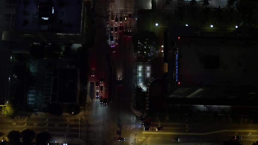 A stunning high-rise view of the bustling city streets and skyscrapers of downtown Miami Florida during nighttime