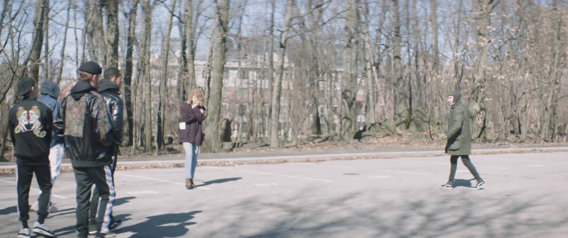The people walk around the parking lot talking together