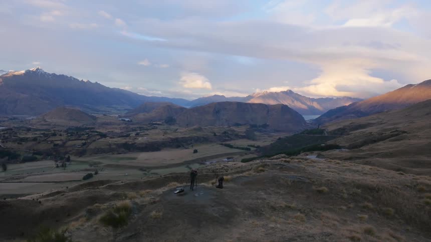 Photographers with their camera standing in the mountains