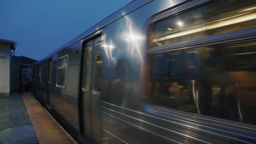 A passenger train making its way into a train station in a metropolis city