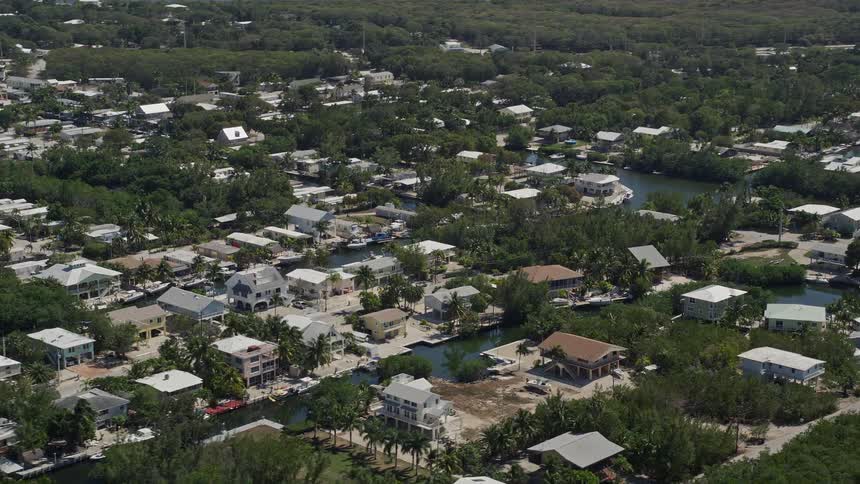 Aerial footage of residential homes situated on canals in Key Largo Florida during the day