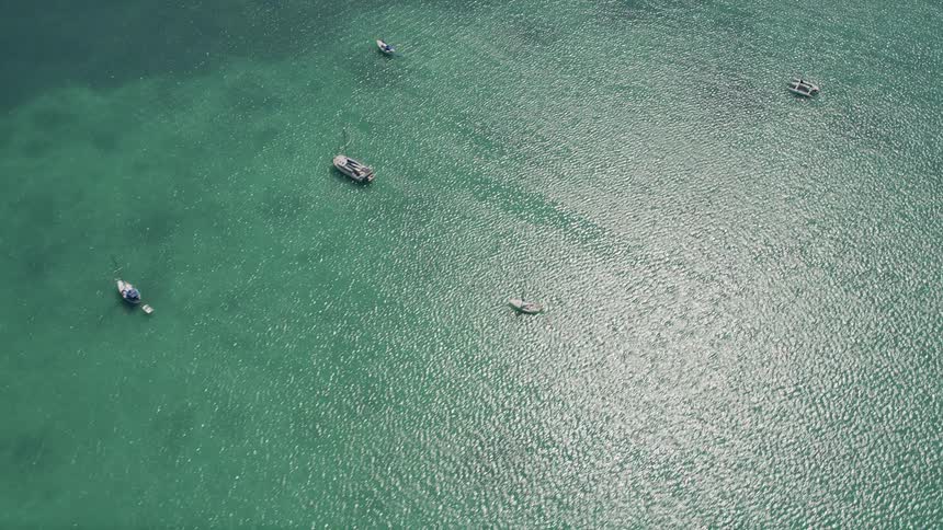 Aerial footage of sailboats and catamarans in the crystal-clear waters of Islamorada Florida