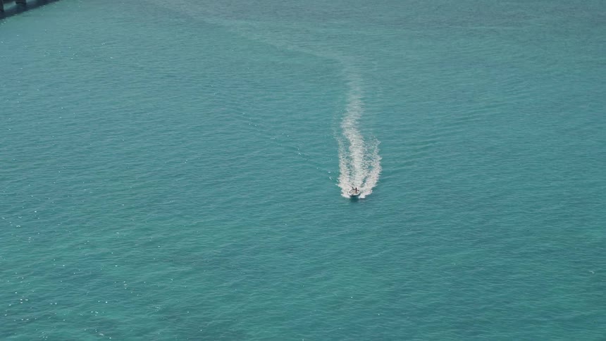 Approaching a speedboat a drone captures aerial footage of the Conch Key area near Marathon Florida as part of daytime aerials in Florida during summer