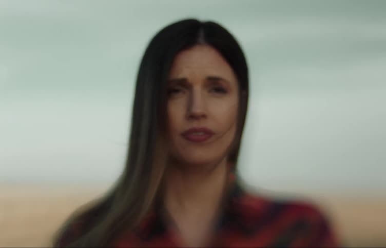 Close up of the face of a woman talking to herself standing in the countryside