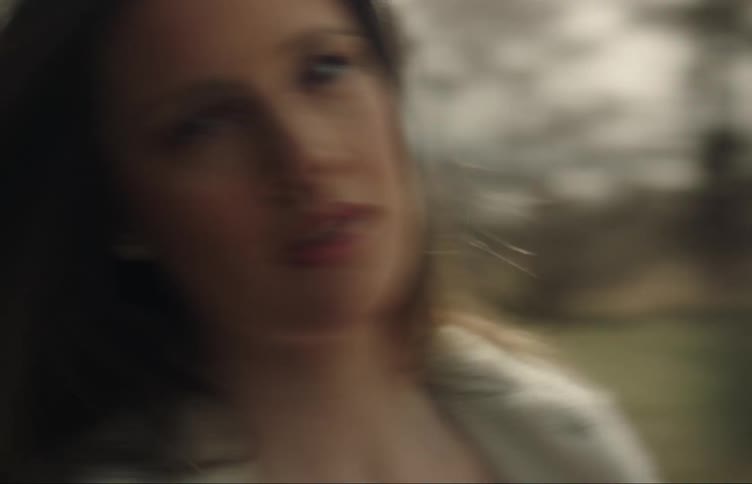 A woman spins around outside