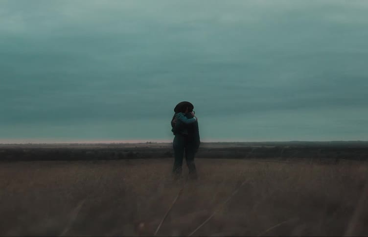 Two people are standing on the field