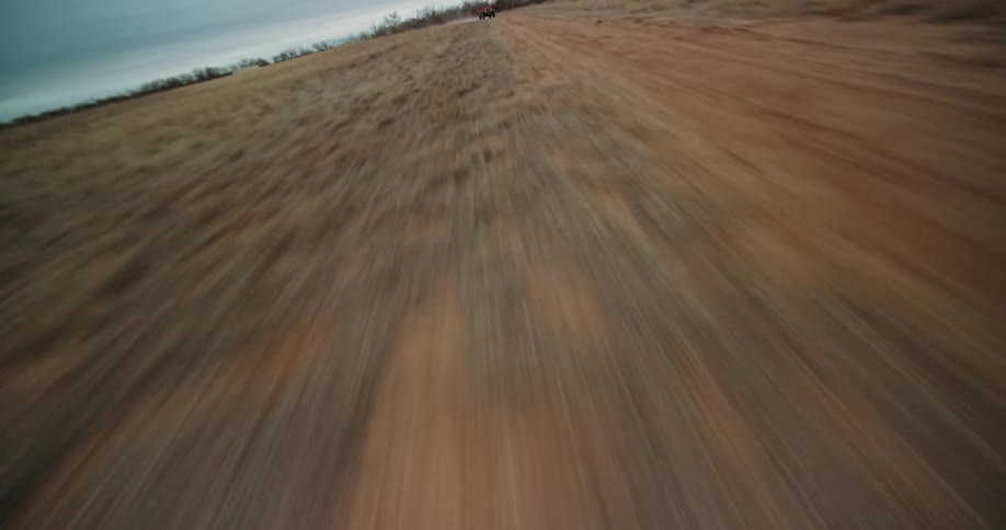 Speeding over a dirt road until a fast jeep appears