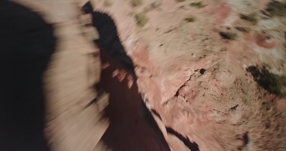 Scrubfills land between rock outcroppings and mesa on sunny day