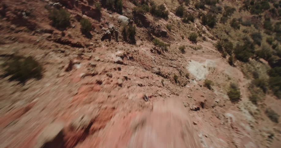 Adventurous aerial shot of rock formations in the badlands at daytime