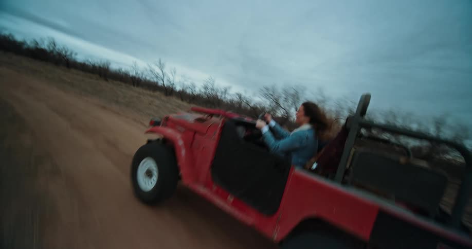 Two people ride in a jeep off road
