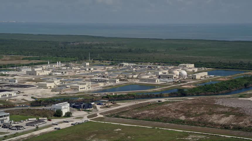 A stunning aerial view of South District Wastewater Treatment Plant located in Homestead Florida surrounded by lush greenery and water as captured by a drone during daytime on a sunny day