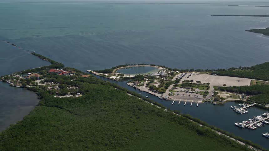 Fly above Homestead Bayfront Parks shoreline enjoying the sunny day and leisure activities of visitors amidst the beautiful South Floridas coastline and nature in this aerial video footage